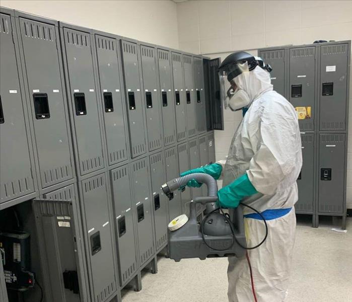 service working cleaning and sanitizing locker room