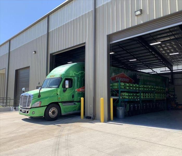 Large SERVPRO semi-truck parked in warehouse.