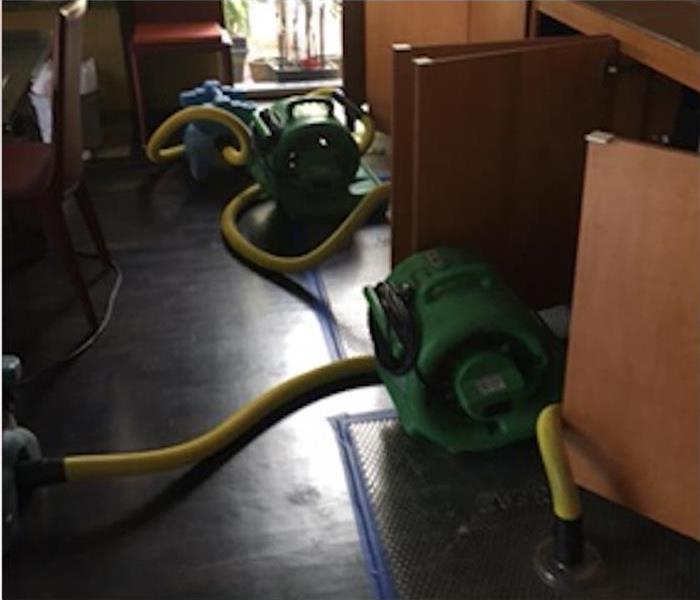 Air movers placed in the kitchen floor and inside kitchen cabinets